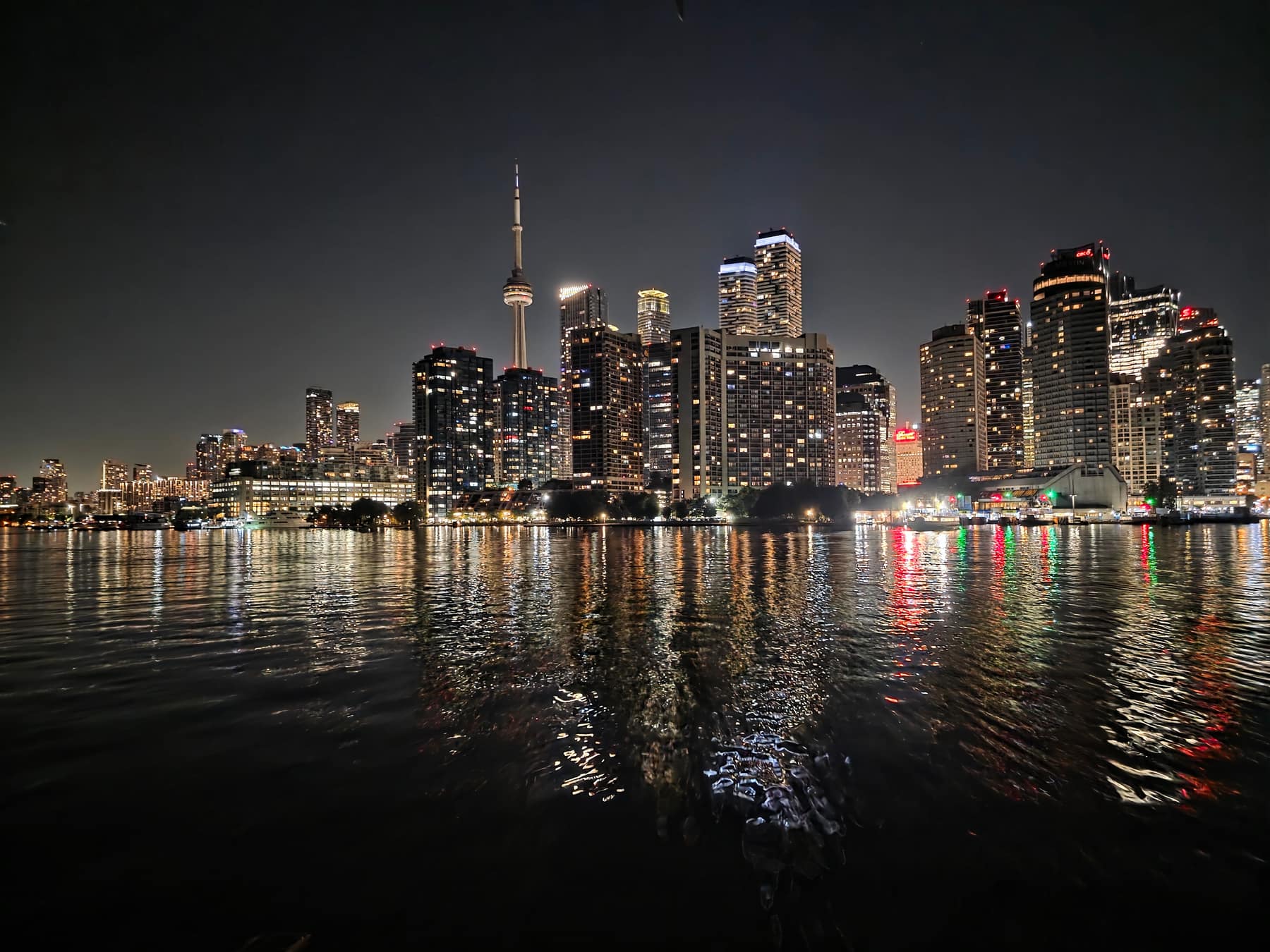 The Toronto waterfront just after midnight, water gone still.