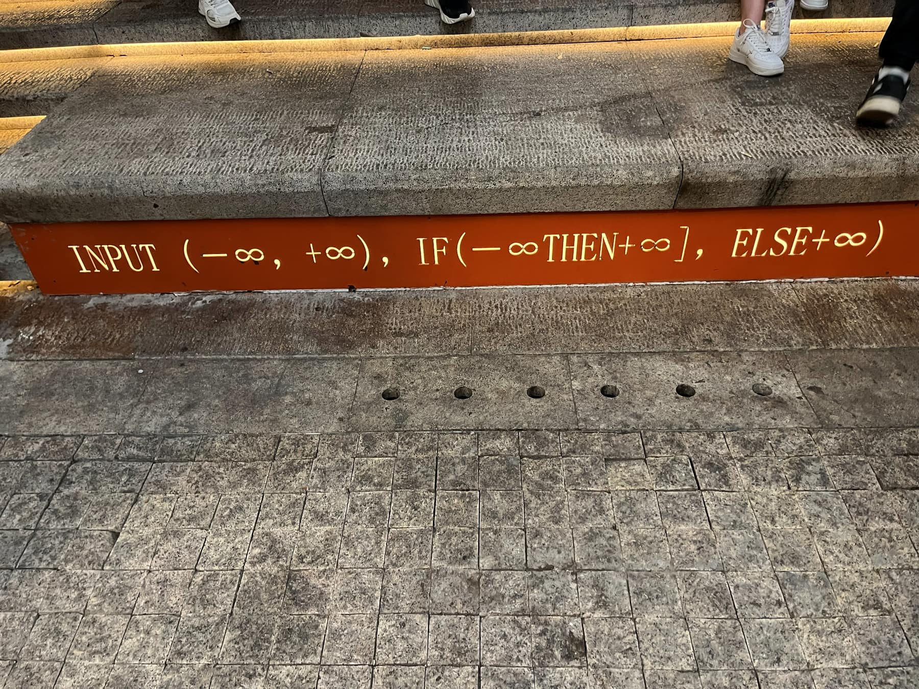 Type set along a stone ledge reading 'INPUT (−∞, +∞), IF(−∞ THEN +∞], ELSE +∞)'.